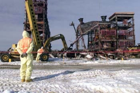 Operating Engineers use Shears to Cut Away Sections of Plant 8.
Plant 8, the Scrap Recovery Plant, recycled residues and scrap from the uranium production process. Ores, concentrates and process residues were roasted to oxidize the impurities and then filtered. The filtered material was converted to free flowing powder and transferred to Plant 2 for further processing. The D&D of the plants consists of surface decontamination, building and equipment dismantlement, size reduction of building material and the loading of demolition debris into rolloff boxes for transfer on the On-Site Disposal Facility. 
Keywords: Fernald Closure Project Fernald Green Salt Plant, Feed Materials Production Center, Fernald, Ohio (FEMP)