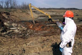 A Supervisor Gives Instructions to an Operating Engineer in Pit 3.
The Waste Pits Remeidal Action Project (WPRAP) involves the remediation of six waste pits, the Burn Pit, the Clearwell, miscellaneous structures, facilities, and soil. More than 1 million tons of contaminated materials are associated with the cleanup project. The Shaw Group, formerly IT Corporation, constructed the remediation facilities for the project, which include a Material Handling Building, where excavated wastes from the pit area will be sorted, blended and treated, Gas Control System/Water Treatment System (GCS/WTS) Building, and the Railcar Loadout Building, where material is loaded into railcars for shipment to Environcare of Utah. 
Keywords: Fernald Closure Project Fernald Green Salt Plant, Feed Materials Production Center, Fernald, Ohio (FEMP)