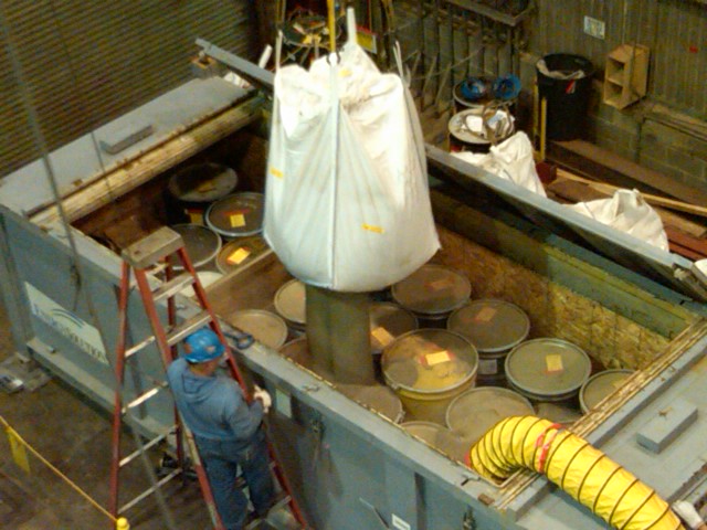 Filling in the spaces
This pic was taken while workers emptied a bag of sand into an intermodal 
for disposal, this  maximized the volume of waste for the container.

Keywords: waste, Fermi 1 decommissioning