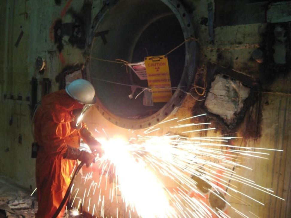 The diamond-wire saw cuts through a section of the bio-shield, with the thermal column shown at the upper left of the photo.
