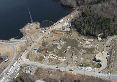 Aerial photo of Yankee Rowe during D&D
Aerial photo of the former Yankee Rowe plant site taken on April 11, 2006.

Decommissioning began in 1993 and will be completed this year. Structural demolition of the plant was completed on June 30, 2005. Below-grade decommissioning will be completed this summer, followed by site grading and restoration. Final radiation surveys of the site will be conducted to demonstrate to state and federal regulators that Yankee has successfully completed decommissioning. The plant site will then be released from its Nuclear Regulatory Commission license.

The transfer of Yankee's used fuel from wet to dry cask storage was successfully completed in June of 2003. The decommissioned Yankee Rowe plant site will not be available for reuse until the Department of Energy meets its legal obligation to remove the used fuel stored on the former plant site. The fuel storage facility will continue to be licensed by the Nuclear Regulatory Commission.
Keywords: Yankee_Rowe