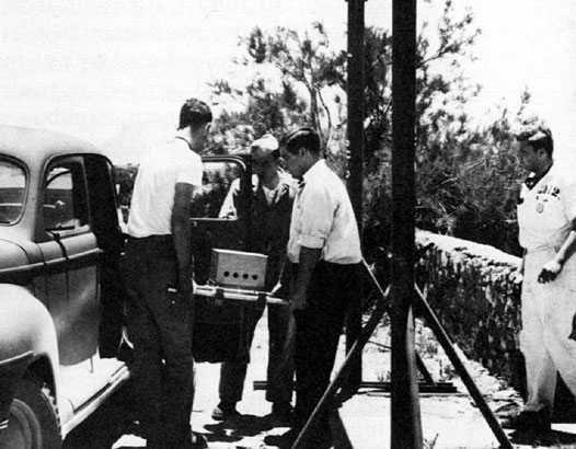 Unloading the Plutonium
Active material for the Trinity device is moved from the sedan that brought it to McDonald Ranch. 
