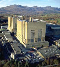 Trawsfynydd
Trawsfynydd Power Station lies within the boundaries of a National Park of considerable beauty and is located on the northern bank of Llyn Trawsfynydd. 

Following the decomissioning of the plant, the existing building structure is to be reduced in height and encased in a new 'Safestore' envelope. The objective is to reduce and in some cases eliminate the buildings impact within the National Park.

The Safestore structure is to provide an aesthetically acceptable, cost effective means of long term, secure storage for specific radioactive materials and structures. As well as minimising the visual impact of the site the structure is based on the following criteria:

The design life shall be 135 years. During the majority of this period it is proposed that the site will be unmanned. The structures shall be intruder resistant with a 9m wall also giving an improved visual balance between the lower and upper levels of the external elevations. 
 
The landscape within the site boundary will reflect the character of the natural surrounding landscape so the there are no visible boundaries and the landscape flows naturally through the site.
Keywords: Trawsfynydd Safestore UK