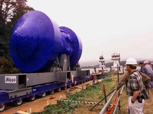 Trojan Nuclear Power Plant (decommissioned)
Workers watch as the Trojan Nuclear Power Plant reactor vessel, covered in blue shrink-wrap, slowly moves onto a barge on the Columbia River near Rainier, Ore., Friday, Aug. 6, 1999. The reactor vessel will travel by river to southeast Washington state over the weekend where it will be buried at Hanford Nuclear Reservation. Trojan was shut down in 1993.
Keywords: Trojan Nuclear Power Plant Rainier Ore (decommissioned)