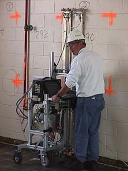 Surface Contamination Monitor
The proportional counters are similar in efficiency to other counters, but have backgrounds associated with small area detectors. This results in improved sensitivity, due to low background, and specific identification of the location of the radioactivity. When performing surface surveys, data is uploaded for each 2" of detector travel as determined by a precision wheel encoder. The survey data is then recorded for each 2" x 2" (25 cm2) area over the entire surface.
