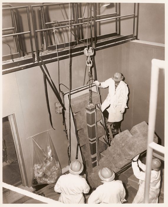 Unloading a Fuel Bundle
Publicity photo from Consumers Power; accompanying caption reads "(2) Unloading a fuel bundle at Big Rock, these men are handling the energy equivalent of about 5,000 tons of coal.  This is one of 56 assemblies made for Big Rock by General Electric's atomic power equipment dept."
Keywords: big rock poing unloading fuel bundle construction