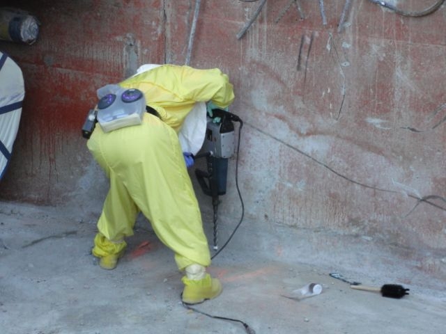 collecting samples
Using a roto-hammer (sic) the sampler creates and collects pulverized concrete particles for analysis.
