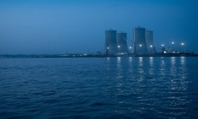 Rooppur cooling towers at dusk over water