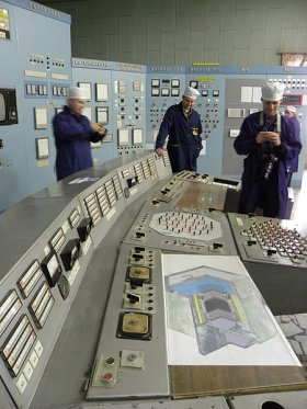 Seversk control room with three staff in overalls