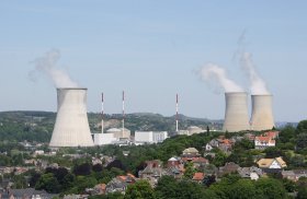 Tihange two cooling towers steaming over houses